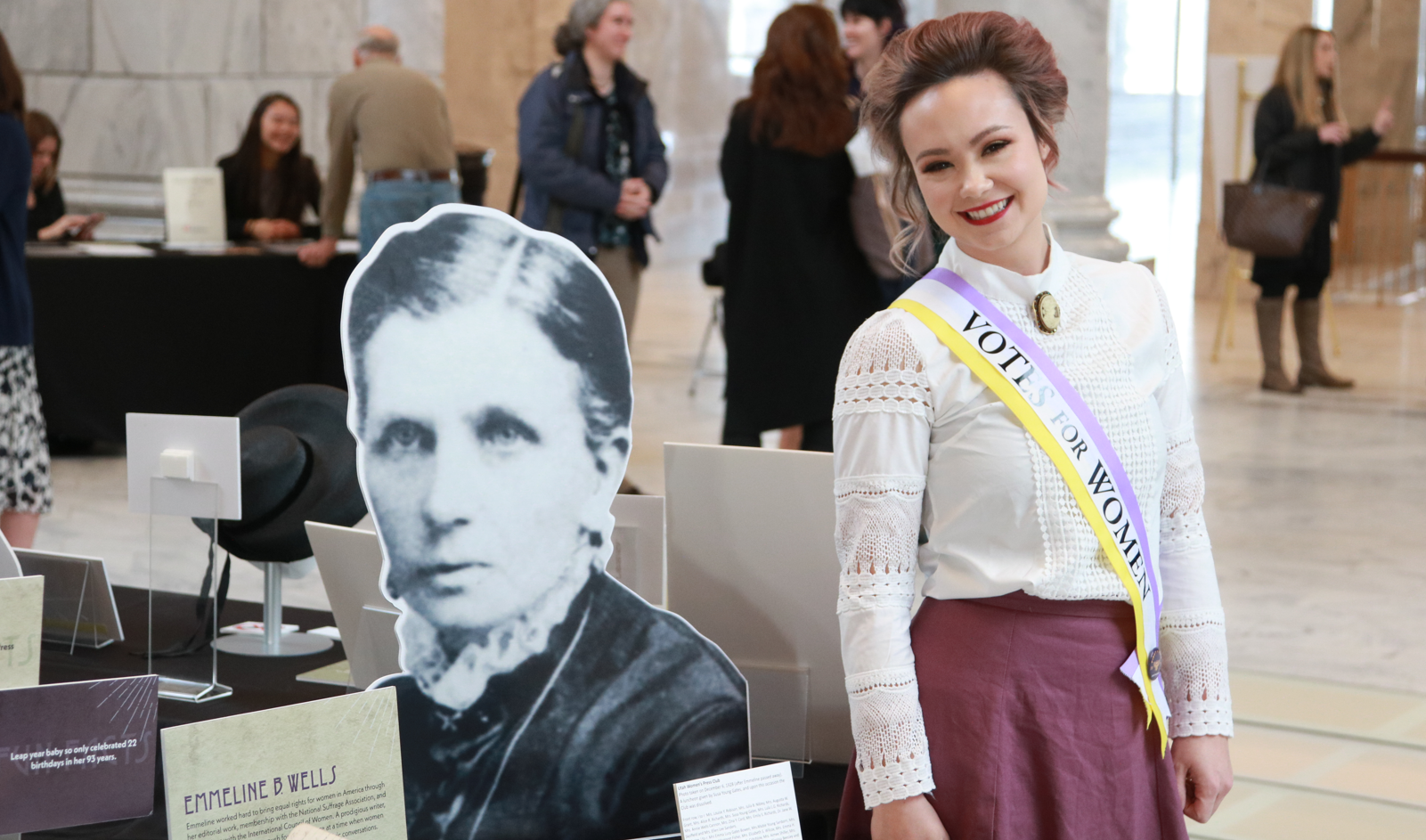 Modern woman with a "Votes for Women" sash
